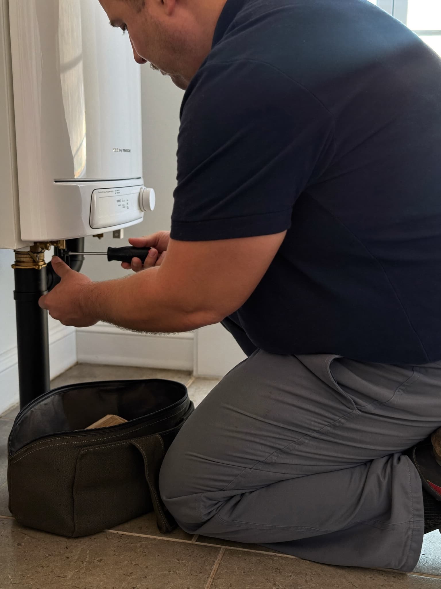 Brookvale engineer servicing a boiler in a Surrey home